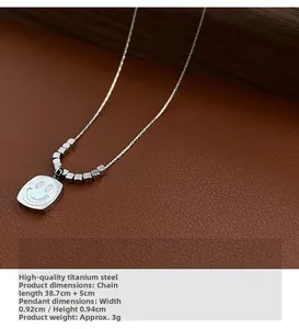 Macro detail of smiley pendant titanium steel necklace with shell inlay on brown leather