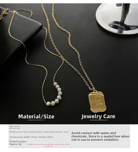 Detail of double-layer titanium steel necklace with natural pearls and engraved square pendant