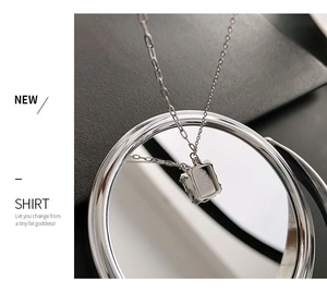 Detailed macro view of silver rectangle pendant with Take your memory engraving