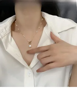 Elegant gold freshwater pearl necklace with OT toggle clasp shown on model