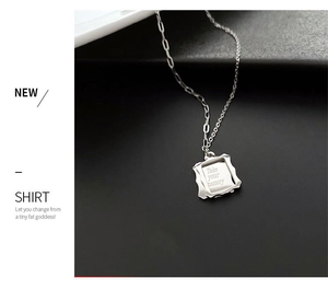 Macro shot of silver titanium steel square pendant with Take your memory engraving