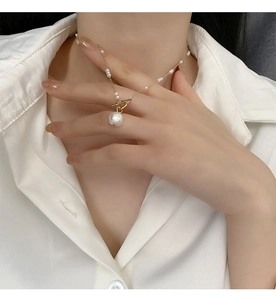 Detailed view of irregular baroque pearl pendant and golden OT clasp on necklace