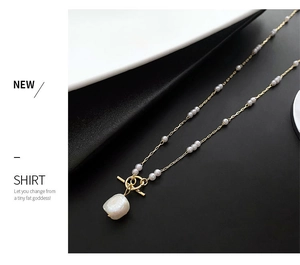 Detail of gold pearl necklace with OT toggle clasp and baroque pearl pendant decoration
