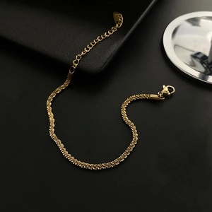 Detail of shimmering gold woven chain necklace with lobster clasp and extension