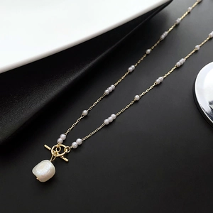 Elegant gold baroque pearl necklace with small beads and decorative OT toggle clasp