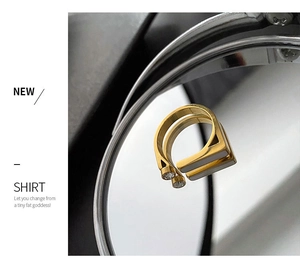 Detailed macro view of a gold-plated stainless steel ring with zircon and white shell inlay