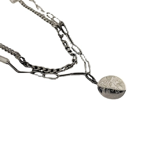 Dual layer silver steel necklace with cuban chains and round face pendant design