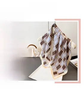 Macro detail of geometric checkered silk scarf with vintage brown and blue rhombus patterns