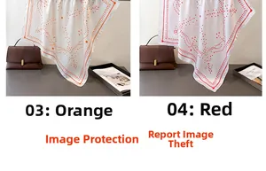 Detail of geometric dot print silk scarves in orange and red patterns on a dark background