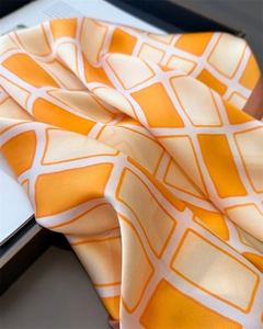 Macro shot of geometric diamond silk scarf with luxurious texture and elegant folds
