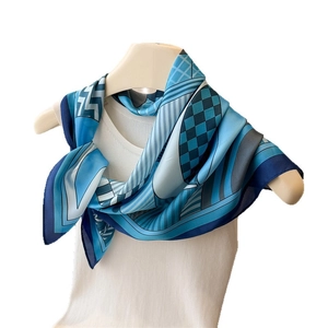 Blue and white geometric silk scarf square with striped patterns displayed on a mannequin
