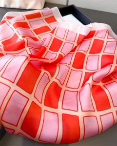 Close-up of pink and orange checkered faux silk scarf showing smooth texture and sheen