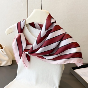 Close-up of elegant red and white striped silk square scarf with pink border detail
