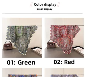 Detail of silk-like paisley pattern scarf in green and red with soft elegant texture