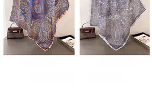 Detail of silk-like paisley square scarves in royal and light blue on a stylish handbag