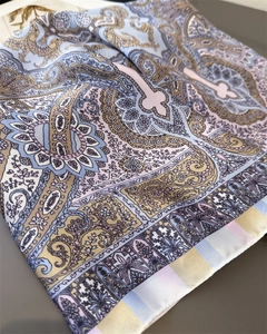 Detail of silk-like scarf featuring classic paisley patterns and a smooth texture