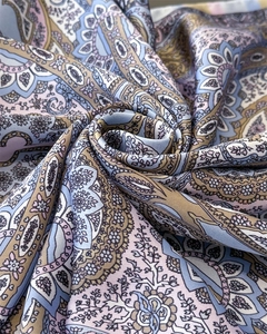 Detailed close-up of bohemian paisley silk scarf showing soft satin texture and floral patterns