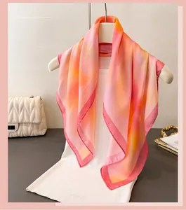 Close-up of lightweight gradient pink and orange silk scarf with delicate hem details