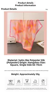 Detailed view of floral silk-like square scarf with pink and yellow gradient pattern