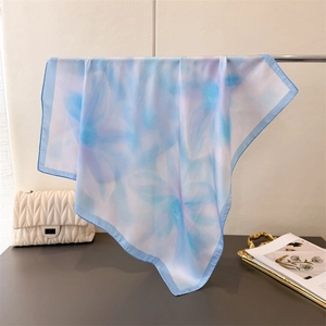 Detail of blue and purple gradient silk scarf showing translucent fabric and soft texture