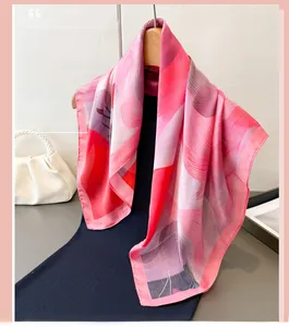 Close-up of pink gradient floral print on faux silk scarf with smooth satin texture