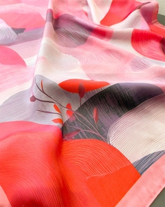 Close-up of abstract gradient floral print silk scarf with glossy texture folds