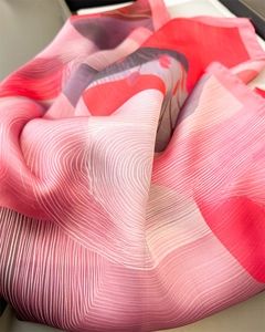 Detailed macro view of the premium silk-like fabric texture and pink gradient print