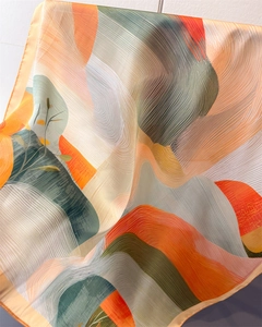 Detail view of abstract art print silk scarf with colorful waves and rolled edges