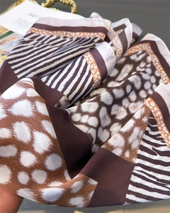 Detailed view of silk-like scarf featuring leopard and zebra print patchwork textures