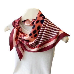Leopard print and stripe silk satin square scarf tied on a white model mannequin neck