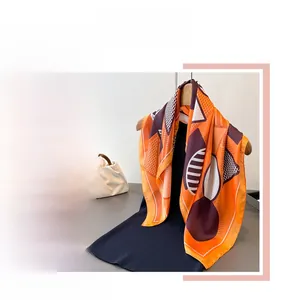 Macro shot of abstract geometric silk scarf with vibrant orange and purple patterns