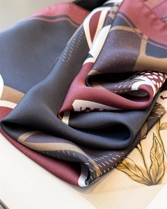 Close-up of geometric pattern satin silk scarf with abstract texture and soft drapes