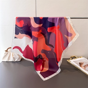 Detailed view of the luxury silk square scarf with colorful abstract horse pattern print