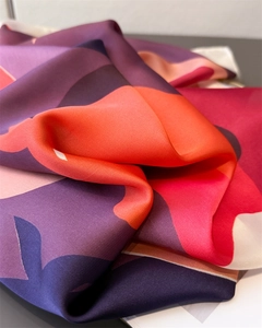 Detailed view of luxury silk scarf with colorful abstract pattern and smooth texture