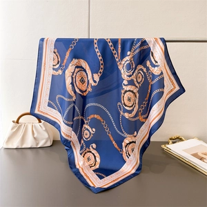 Close-up of elegant chain print silk scarf draped naturally to show pattern and texture