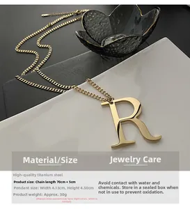 Macro shot of large golden letter R pendant necklace with titanium steel specifications