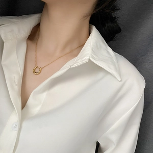 Minimalist gold U-shaped horseshoe pendant necklace on a polished chain for women