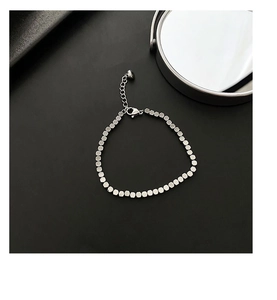 Detail of square bead titanium steel bracelet featuring lobster clasp and extension chain