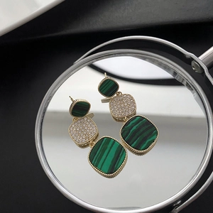 Elegant green malachite drop earrings with cubic zirconia and gold finish on mirror