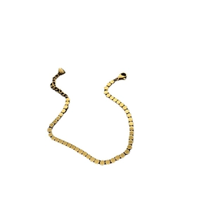 Gold titanium steel bracelet with small flat discs and a delicate heart pendant charm