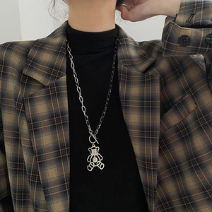 Hip hop hollow bear pendant necklace with OT toggle clasp on a stylish brown blazer