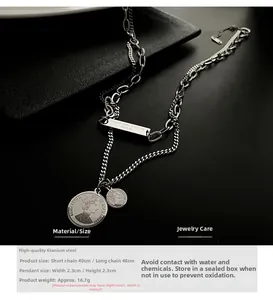 Detail of silver double-layered titanium steel necklace with engraved coin pendants