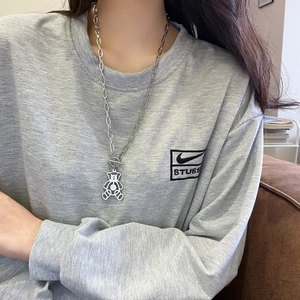 Retro titanium steel OT chain necklace featuring a hollow bear pendant on a model