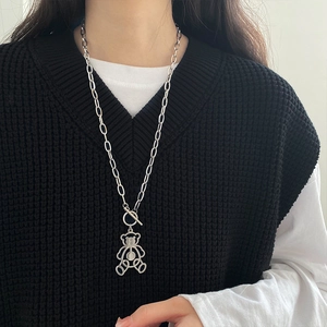 Detailed view of long hollow bear pendant with chunky silver chain and OT toggle clasp