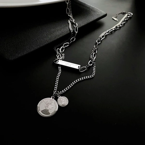 Double-layered silver titanium steel necklace featuring coin pendants and engraved metal tag