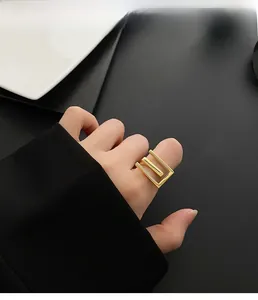 Close-up of minimalist 18k gold plated titanium steel ring with geometric mountain design