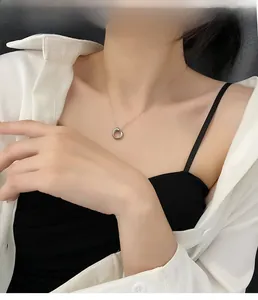 Minimalist geometric circle pendant necklace in silver finish worn on model collarbone