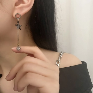 Elegant long tassel earrings with black star pendant and zircon on Asian model