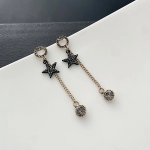 Elegant gold chain tassel earrings with black star charms and grey crystal pendants