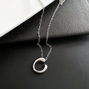 Minimalist silver-colored titanium C-pendant necklace with polished geometric design